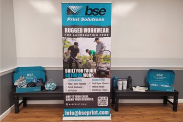 Retractable banner for trade show visibility with promotional products staged around it 